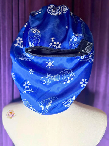 AQueenzDen blue satin bonnet with white paisley pattern and zipper pocket. Reversible design for hair protection.