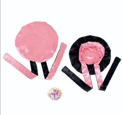 AQueenzDen double layer reversible satin bonnet in pink and black with adjustable ties for hair protection.