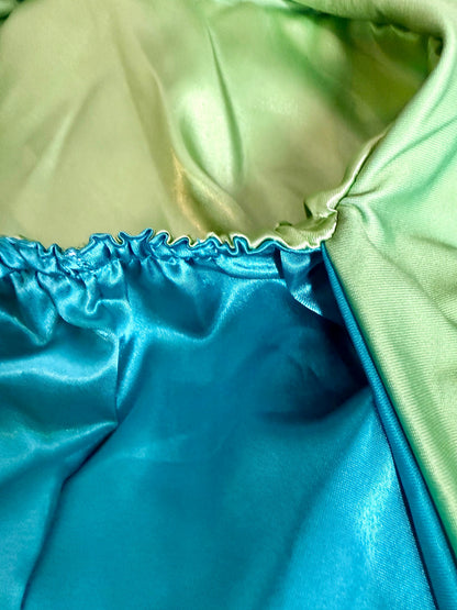 AQueenzDen reversible double layer satin bonnet in teal and light green with adjustable ties. Silky smooth material for hair protection.