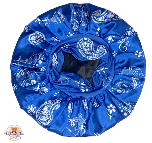 AQueenzDen Premium satin hair bonnet in blue with white paisley pattern. Features a reversible design and a zipper pocket.