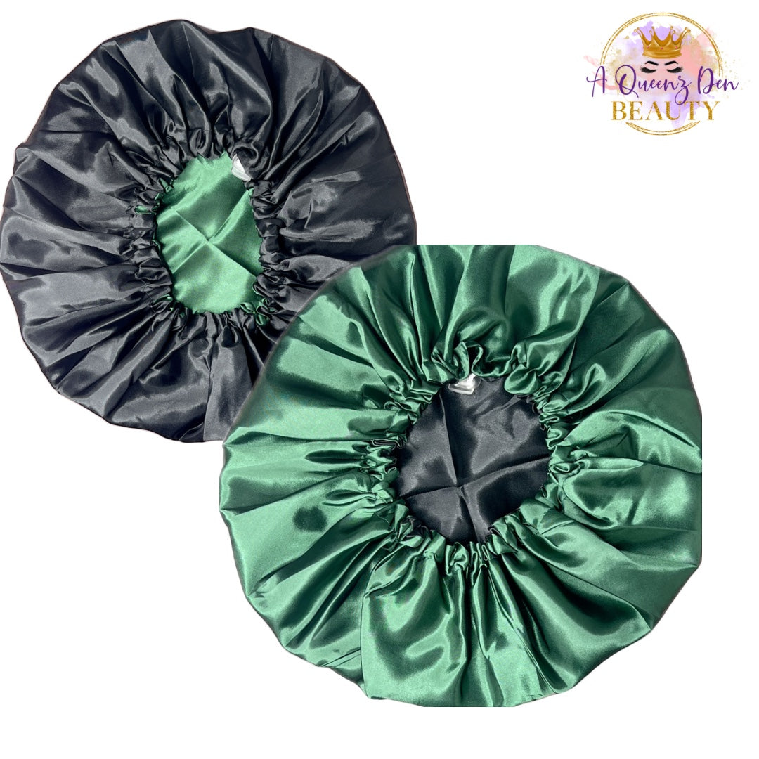 A Queenz Den adjustable double layer reversible satin bonnet in black and emerald green. Designed for natural, curly, and loc'd hair.