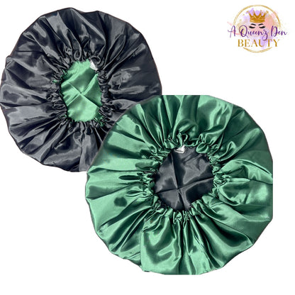 A Queenz Den adjustable double layer reversible satin bonnet in black and emerald green. Designed for natural, curly, and loc'd hair.