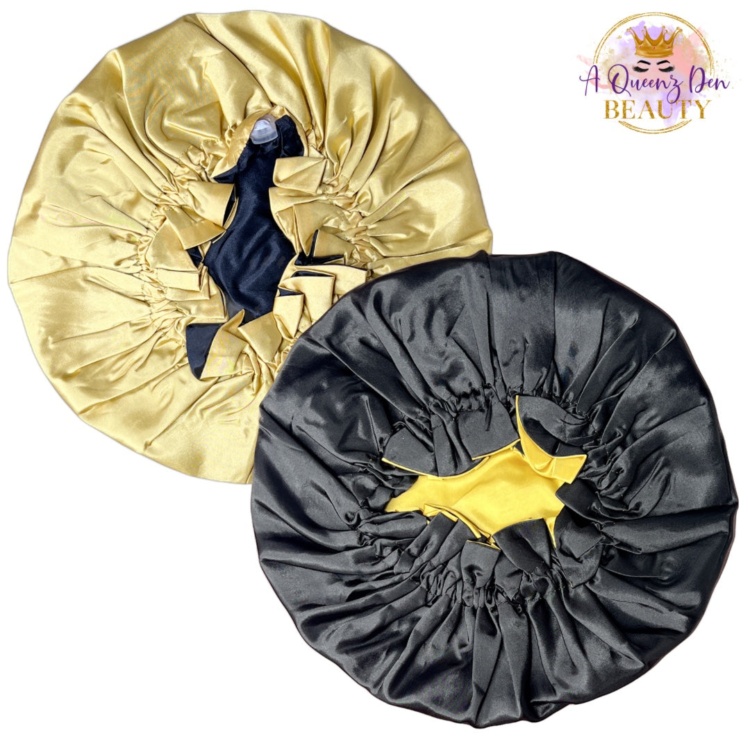 A Queenz Den adjustable double layer reversible satin bonnet in gold and black, designed for natural hair.