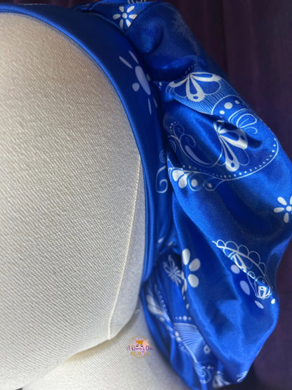 AQueenzDen blue and black reversible satin bonnet with white paisley pattern and zipper pocket for hair protection.