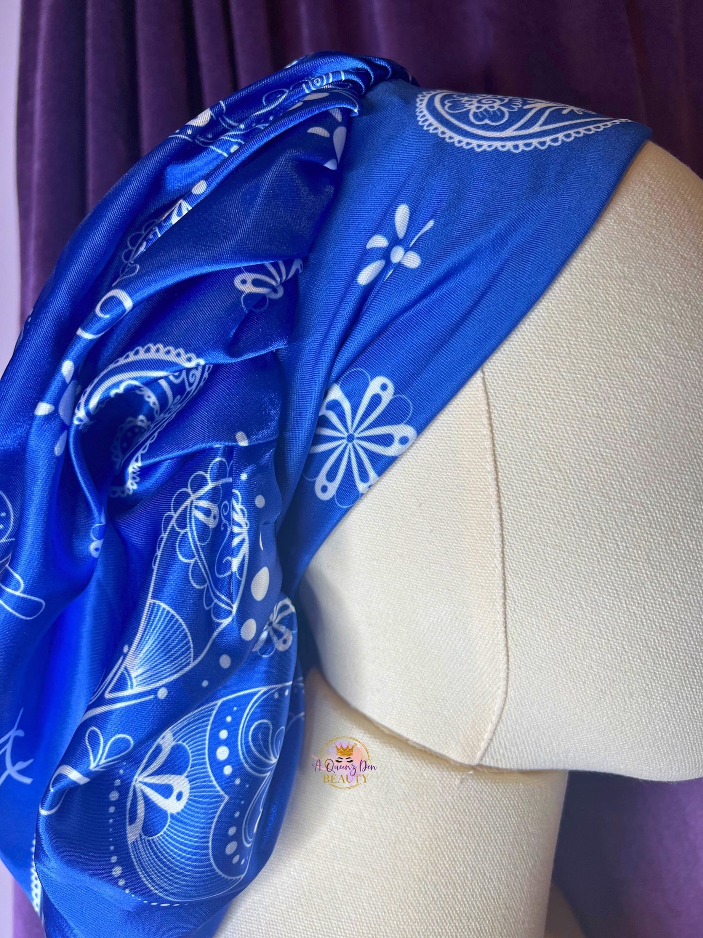 AQueenzDen blue and black reversible satin hair bonnet with white paisley pattern and zipper pocket for hair protection.