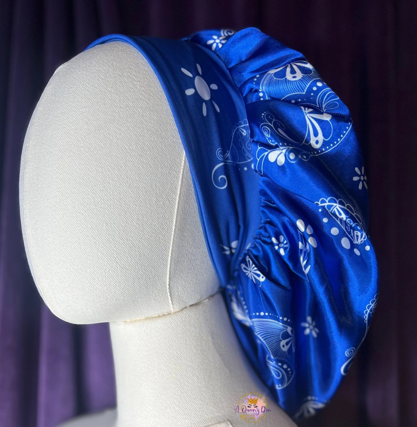 AQueenzDen blue and black satin hair bonnet with reversible paisley pattern and zipper pocket. Lightweight and breathable.